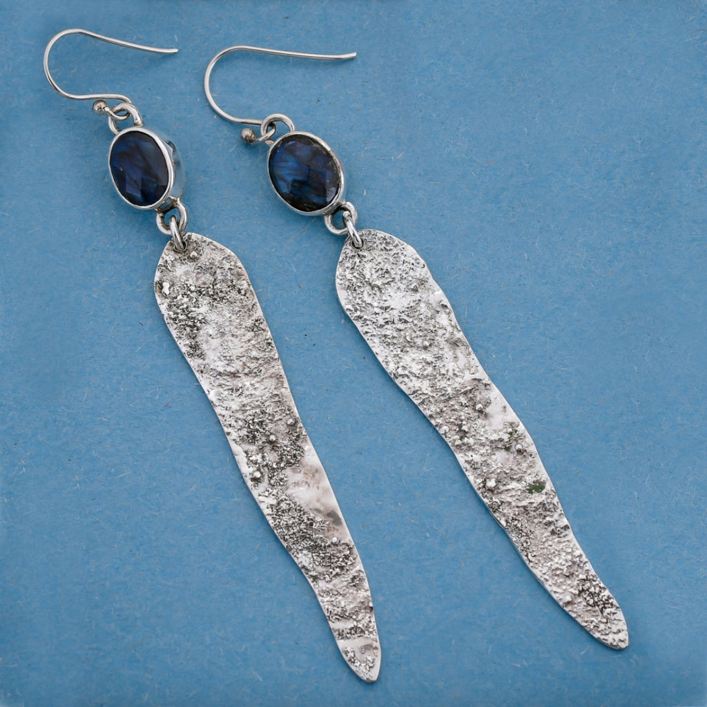 Labradorite earrings on a blue background